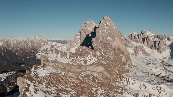 Slow dolly back drone shot over impressive mountain ridge