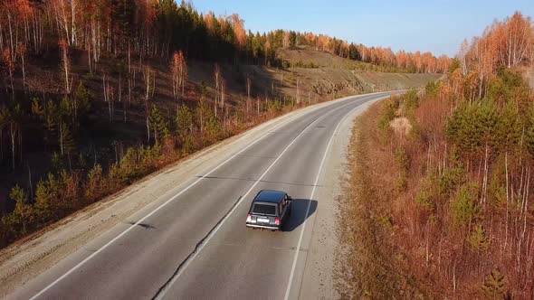 Cinematic Drone Shooting Vehicle Riding Along Gravel Road, Autumn Landscape