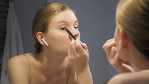 Attractive Woman Putting on Make Up with Brush Adding Mascara on Eye