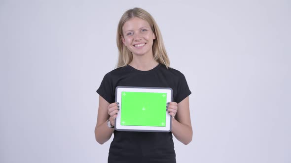 Young Happy Blonde Woman Showing Digital Tablet