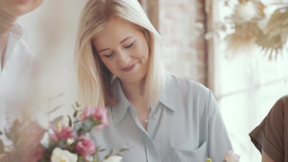 Beautiful Woman Decorating Flower Bouquet in Hatbox