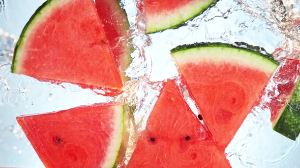 Super Slow Motion Shot of Splashing Fresh Melon Cuts Into Water at 1000 Fps