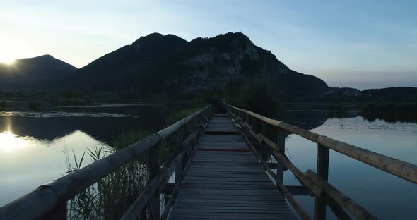 POV Point of View Walking Along Bridge Wood Path on Lake at Sunrise in Summer