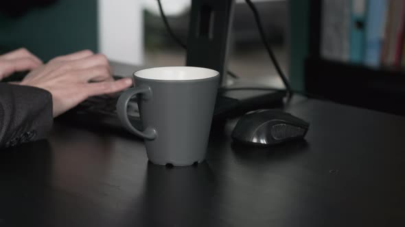 Entrepreneur Spills Coffee on Desk While Working