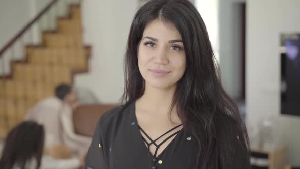 Beautiful Middle Eastern Woman with Hazel Eyes and Long Dark Hair Looking at the Camera and Smiling