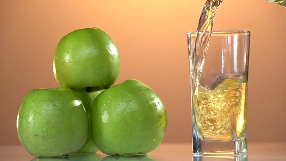 Pouring Apple Juice on Closeup Shot Into the Glass