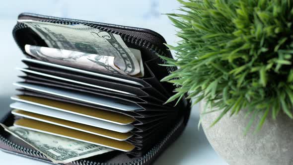 Close Up of Credit Cards and Cash in a Wallet on White Background