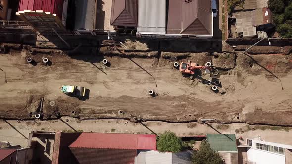 Aerial Construction Site with Machinery, Bulldozer, Excavation.