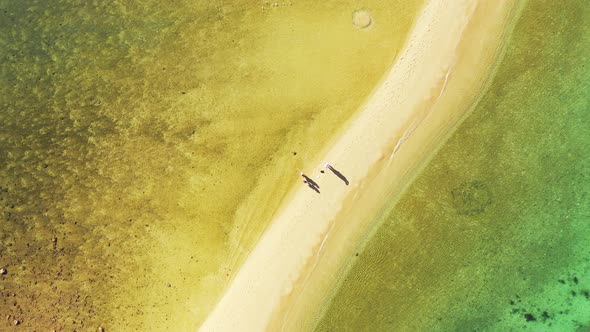 Yellow green water of shallow lagoon on both sides of white sandy beach on beautiful coastline of tr