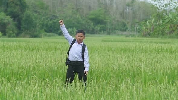 Boy Celebrating In Rice Field