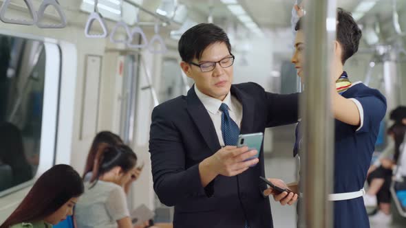 Businessman and Woman Talking on Public Train