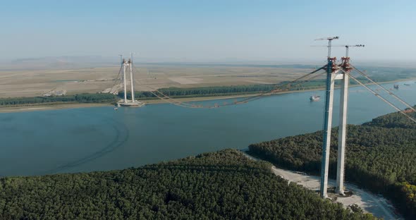 Main Towers Of Braila-Tulcea Bridge Stands On The Riverbanks Of Danube River In Romania. aerial. pul