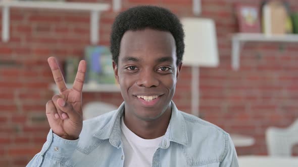 Successful African Man Showing Victory Sign 