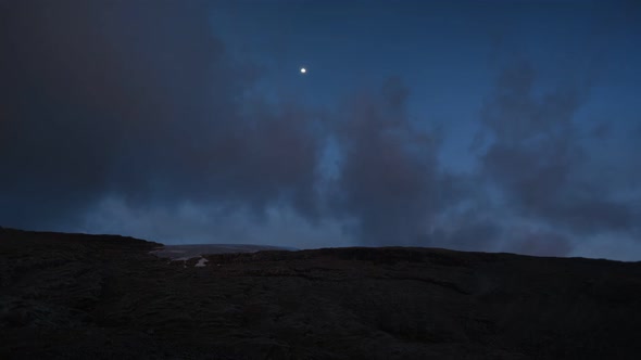 Time lapse of twilight turning to night over mountains