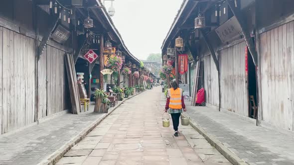 Sanitation Woman Working in Chinese Ancient Town