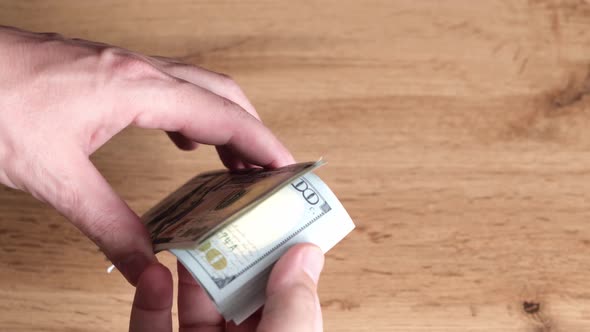 In hands bundle hundred dollar bill, cashier counting money, business and finance.