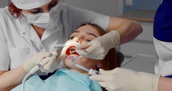 Dentist Performs Professional Teeth Cleaning for a Beautiful Female Patient