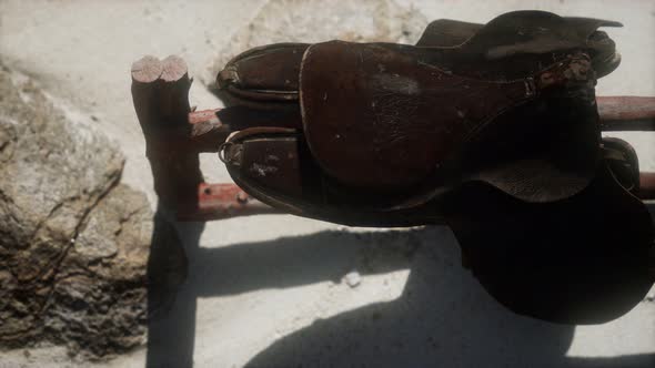 Rider Leather Saddle on Fence in Desert