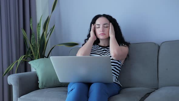 Young Woman Working on Laptop, Sitting on Sofa at Home, Businesswoman Sits at Home Works Remotely on