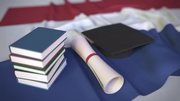 Graduation Cap Books and Diploma on Flag of the Netherlands