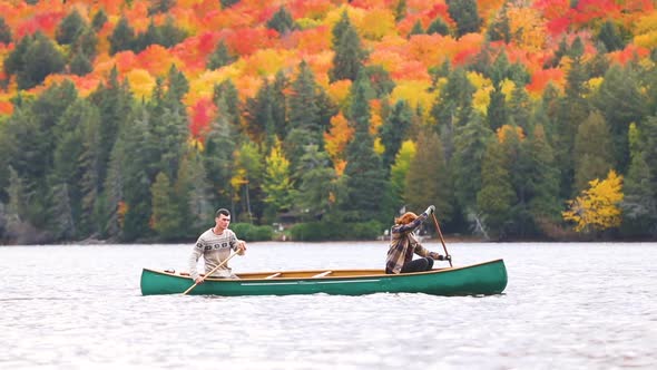 Couple canoeing on a lake in Canada