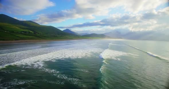 Repetitive sea waves and green hills 4k