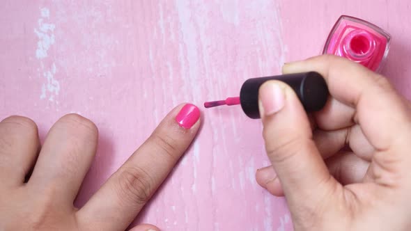 Women Applying Nail Polish on Finger Top Down 