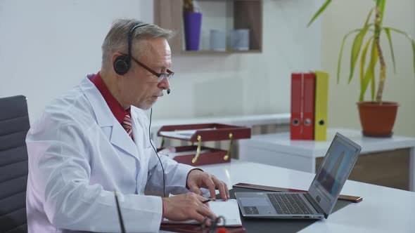 Doctor during online consultation. Online video conference call with doctor on laptop