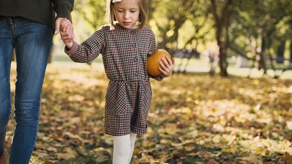 Handheld video shows of mother and daughter during autumn walk