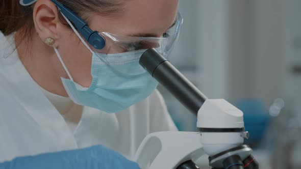 Specialist Analyzing Dna on Microscope in Laboratory