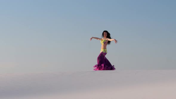 Graceful Dancer Against the Sky Dancing Belly Dance in a Brilliant Outfit