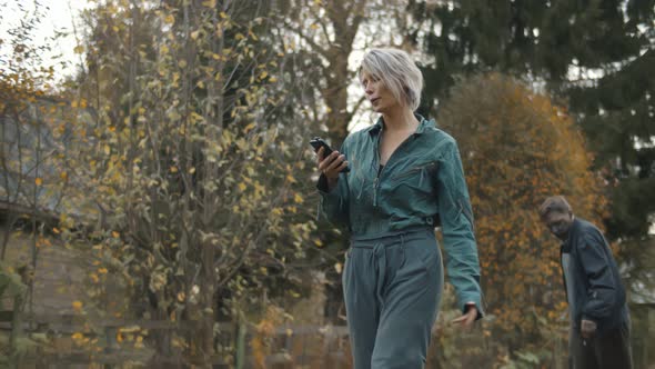 Undead Monster Chasing Female in Headphones and with Smartphone