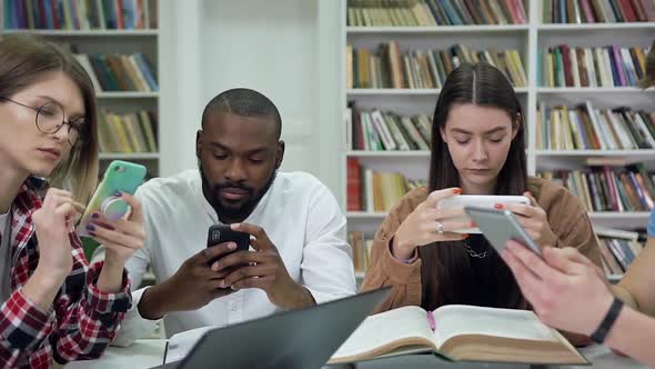 Modern Multiethnic Students which Using their Phones During Working Over University  alt