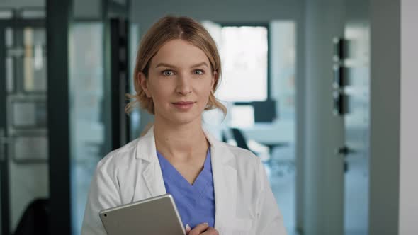 Portrait of smiling caucasian female doctor in medical clinic. Shot with RED helium camera in 8K.