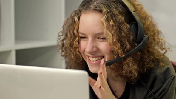 Smiling Teenage Girl with Laptop and Headphones