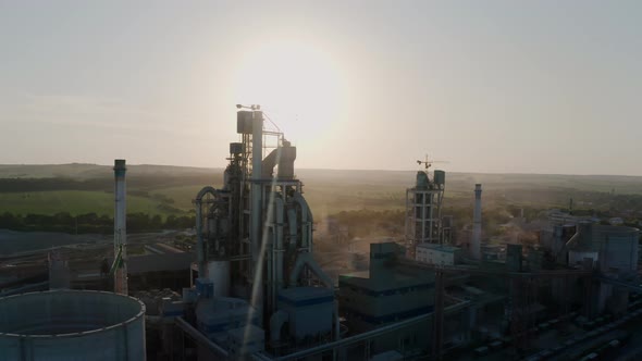 Cement Plant with High Factory Structure at Industrial Production Area at Sunset