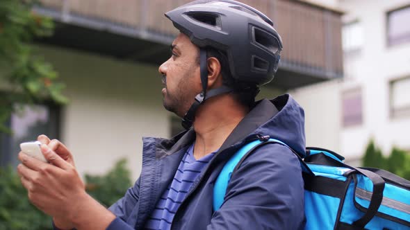 Delivery Man with Bag and Bicycle Calling on Phone