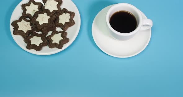 Stop Motion Animation Of Coffee With Pastries Top View On A Blue Background alt