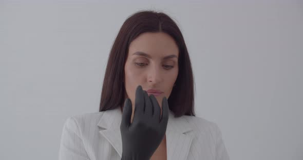 The Beautician Wears Black Gloves For Examination