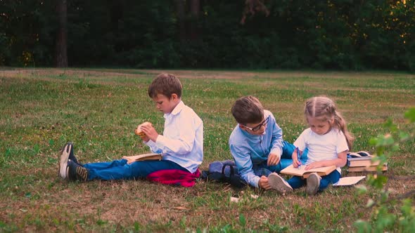 Boy in Glasses Explains Math to Girl Sitting Near Classmate