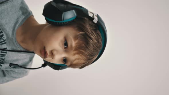 Vertical Video Young Gamer in Headphones