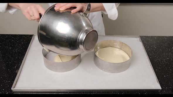 Woman Hands Pouring Cake Batter Into Cake Mold Using a Spatula and Stainless Bowl