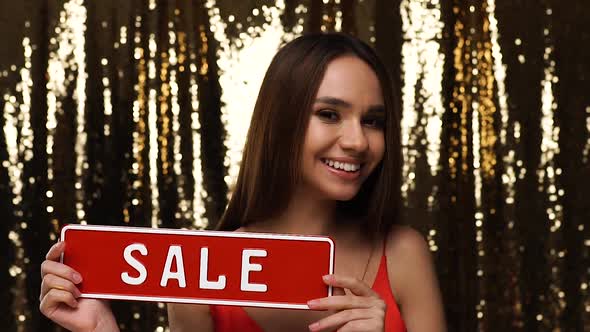 Holiday Sale. Beautiful Woman With Red Discount Board In Hands