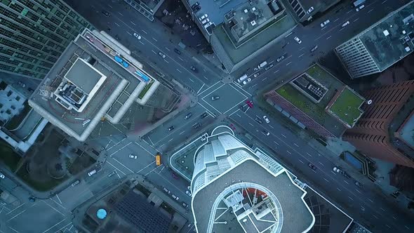 Cinematic aerial view of a busy downtown intersection.