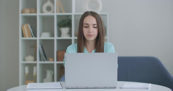 Focused Business Woman Entrepreneur Typing on Laptop Doing Research. Young Female Professional