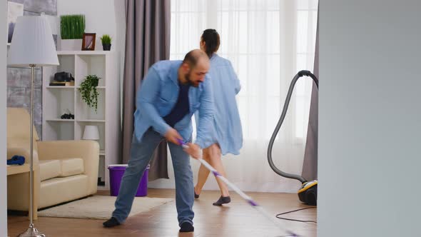 Man Mopping the Floor