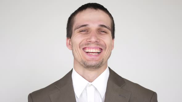 Portrait of Young Laughing Attractive Successful Businessman on a White Background
