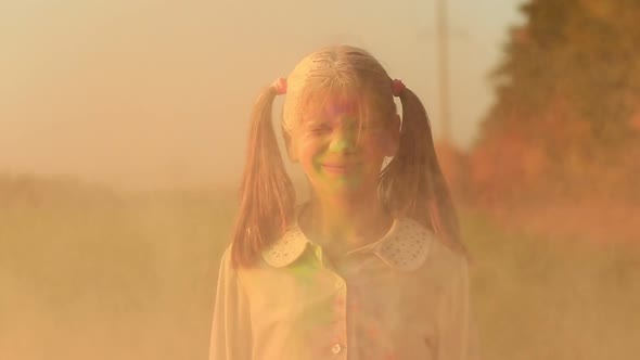 Little Girl with Two Tails Having Fun at Festival of Colors Holi