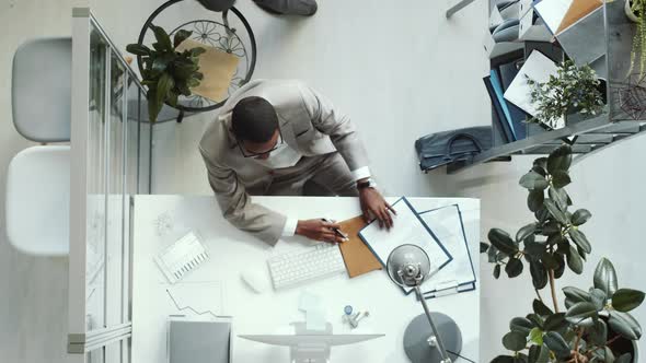 Time Lapse of Afro-American Businessman Working in Office