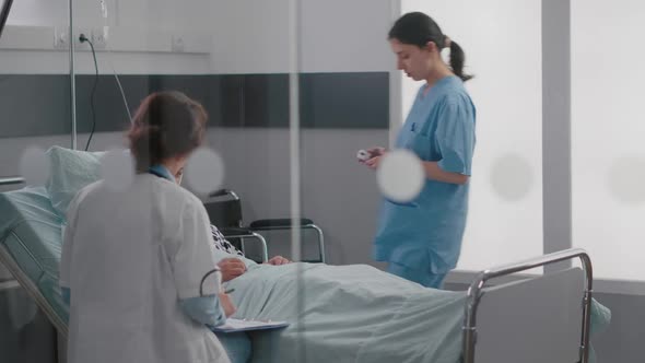 Specialist Doctor in Medical Uniform Checking Sick Man Writing Disease Expertise